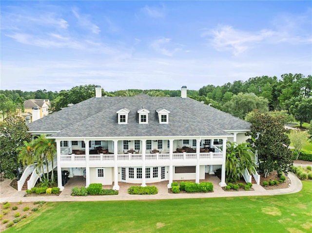 back of property featuring a yard