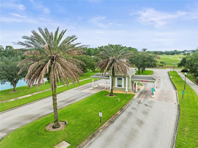 view of front of property with a front lawn, driveway, and an attached carport