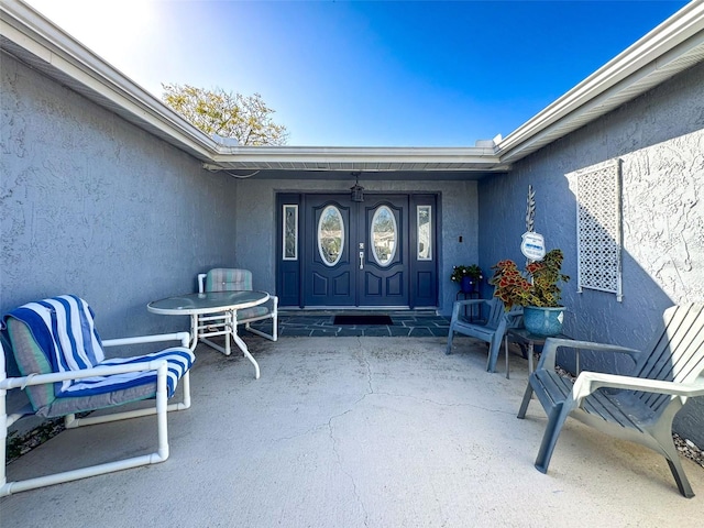 doorway to property with a patio area and french doors