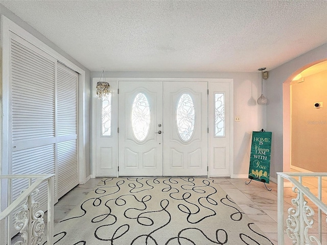 foyer with a healthy amount of sunlight and a textured ceiling