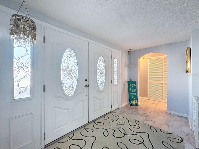 entryway with a textured ceiling and a healthy amount of sunlight