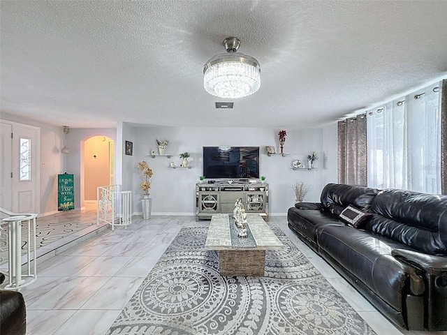 living room with a textured ceiling