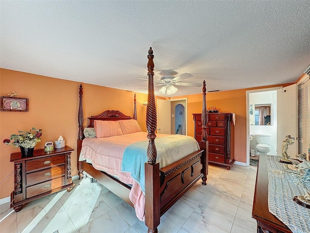 bedroom featuring a textured ceiling, connected bathroom, and ceiling fan