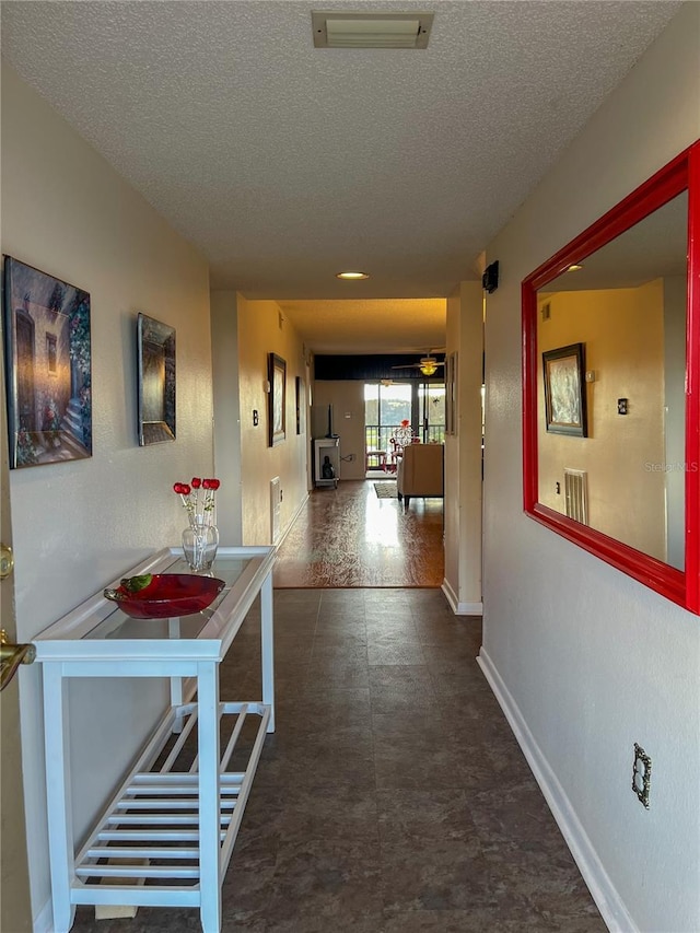 hall with a textured ceiling