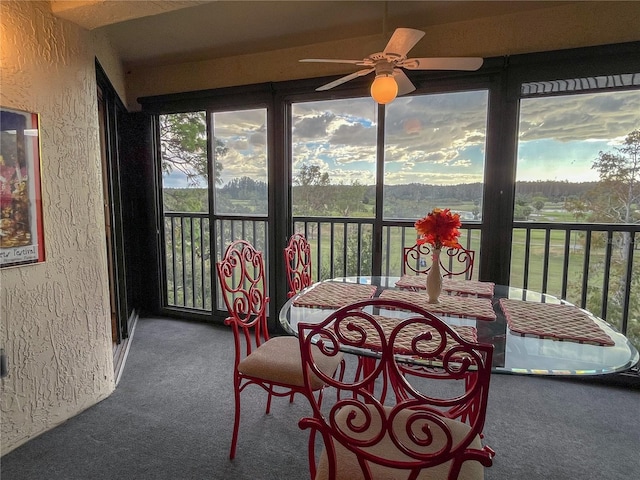 sunroom featuring ceiling fan