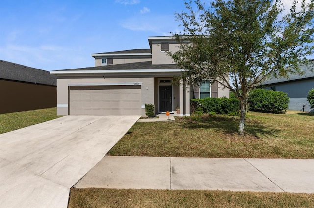 view of front of property with a front lawn and a garage