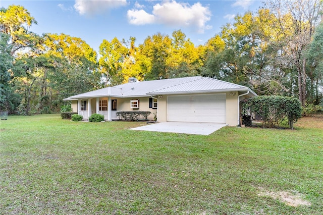 view of front of house with a garage, a front yard, and covered porch