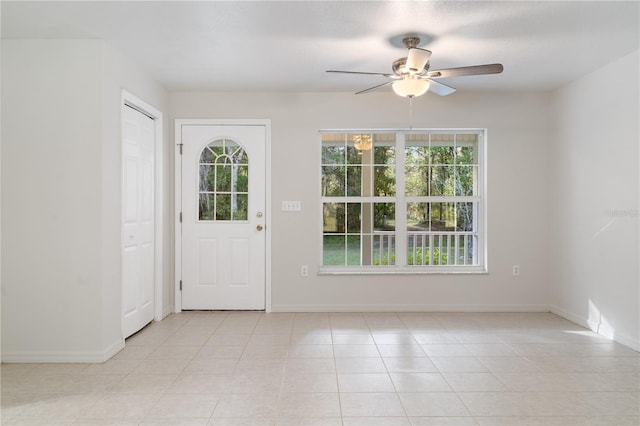 doorway to outside featuring light tile patterned flooring and ceiling fan