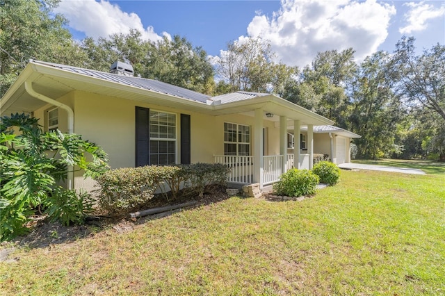 single story home with a garage, a porch, and a front yard