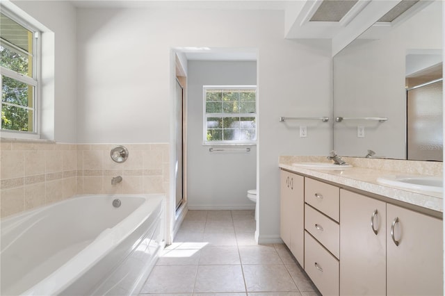 full bathroom with plenty of natural light, vanity, tile patterned floors, and toilet