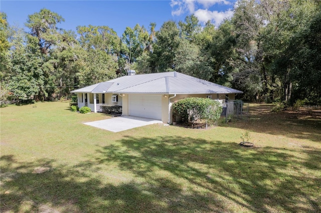 back of property with a garage and a yard