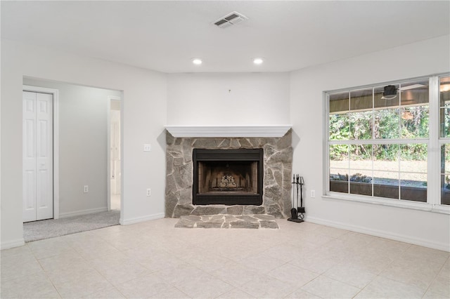 unfurnished living room with a stone fireplace