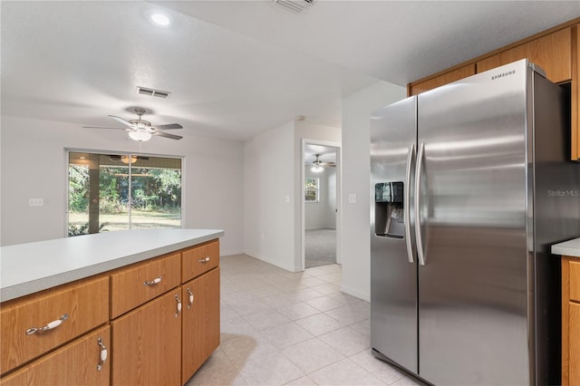 kitchen featuring stainless steel fridge and light tile patterned floors