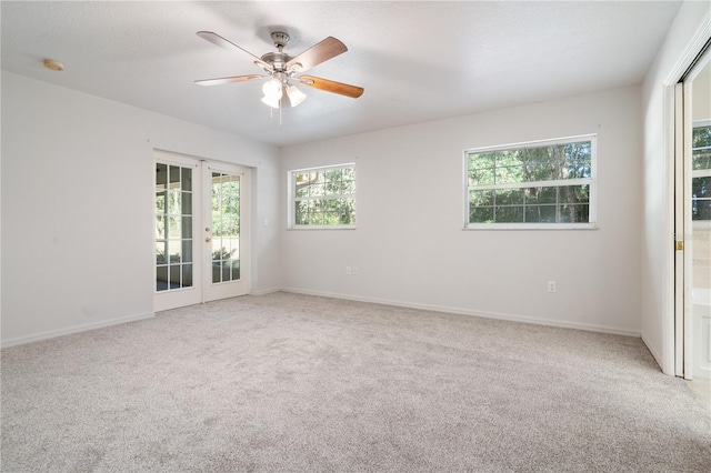 empty room with french doors, carpet flooring, and ceiling fan