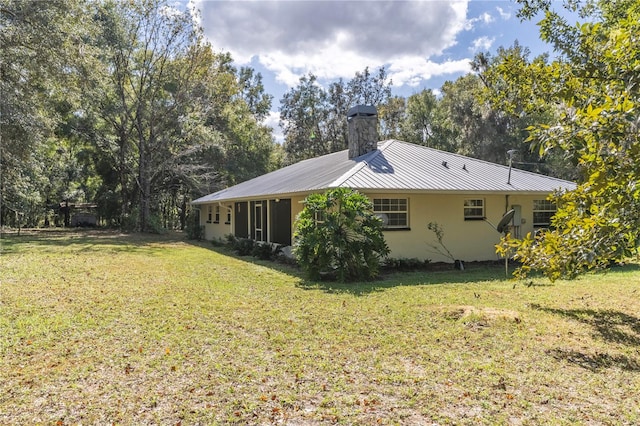 view of side of property with a yard