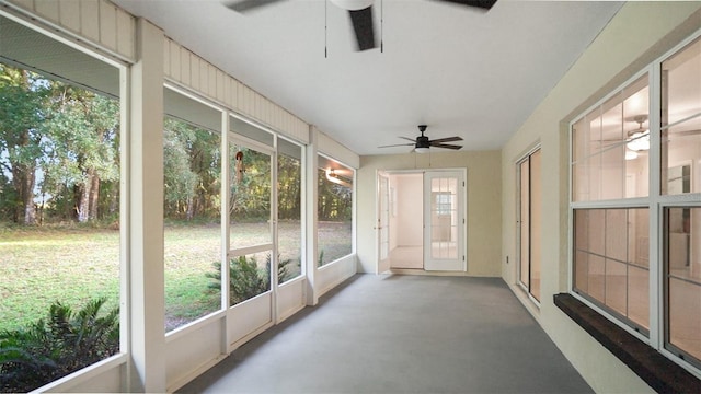 unfurnished sunroom with ceiling fan