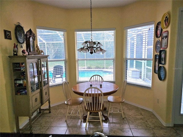 dining room featuring tile patterned flooring and a notable chandelier