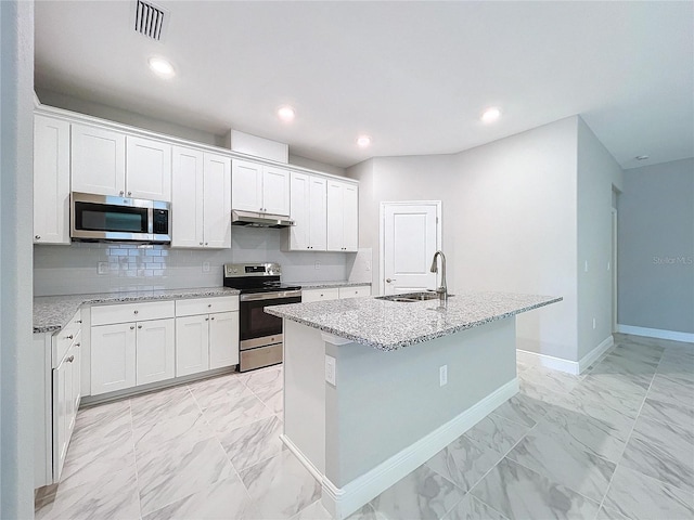 kitchen featuring stainless steel appliances, a sink, white cabinetry, marble finish floor, and an island with sink