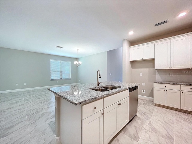 kitchen with a center island with sink, decorative light fixtures, a sink, white cabinetry, and stainless steel dishwasher