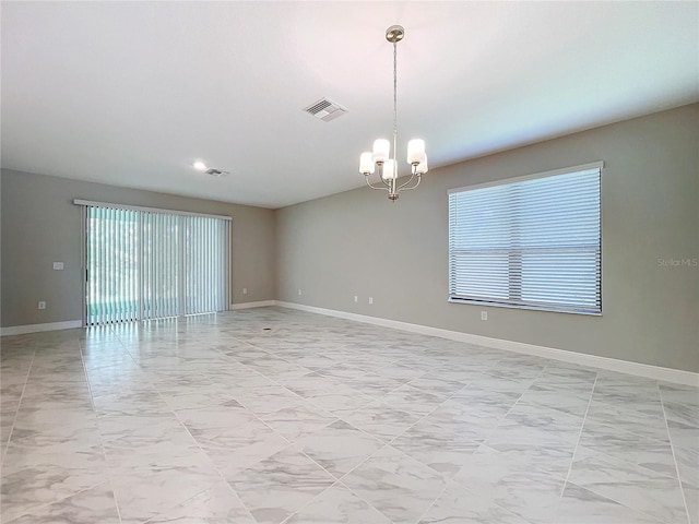 spare room featuring baseboards, marble finish floor, visible vents, and an inviting chandelier