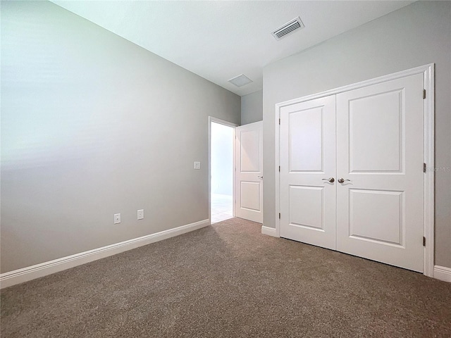 unfurnished bedroom featuring a closet, baseboards, visible vents, and carpet flooring