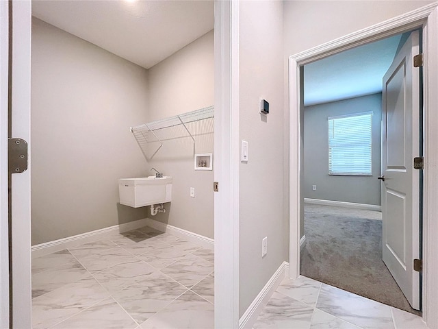 laundry area featuring marble finish floor, baseboards, laundry area, and washer hookup