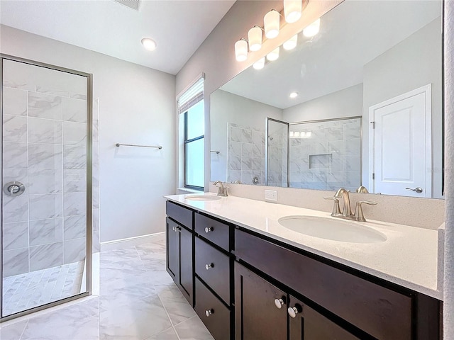 full bath with marble finish floor, double vanity, a sink, and a walk in shower