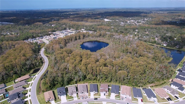 bird's eye view with a water view, a residential view, and a wooded view