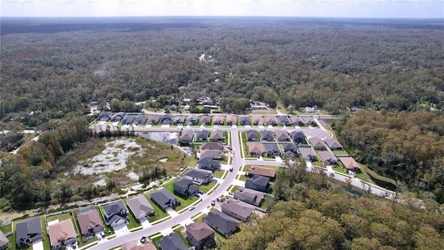 aerial view featuring a residential view and a wooded view