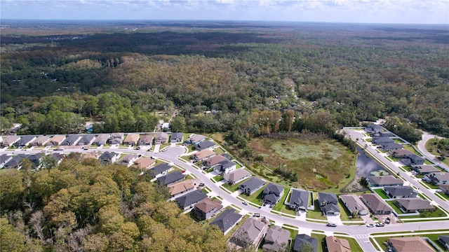 bird's eye view with a residential view and a wooded view