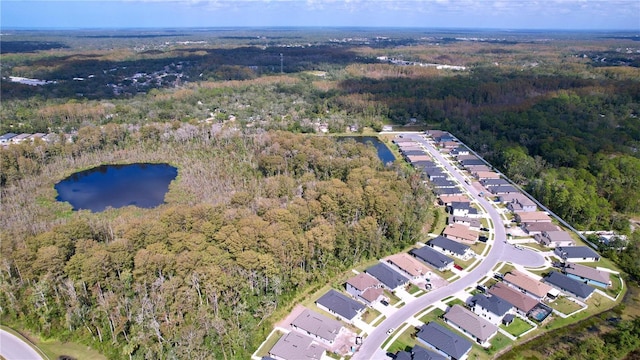 bird's eye view with a water view, a residential view, and a wooded view