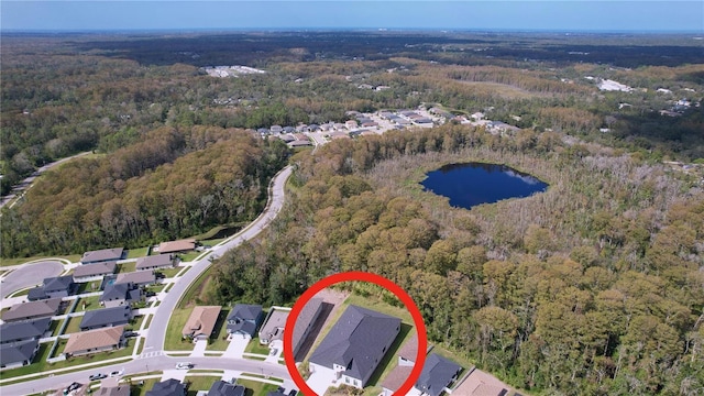 aerial view with a residential view, a water view, and a forest view