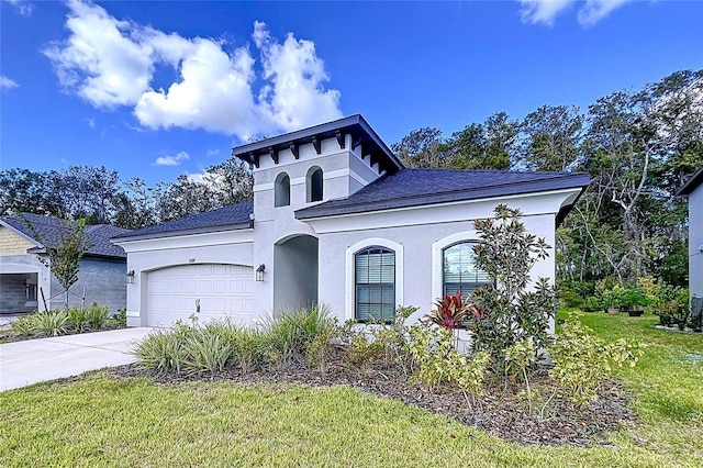 view of front of home with a front yard and a garage