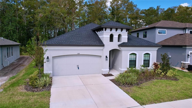 mediterranean / spanish home featuring a garage, a front yard, roof with shingles, and stucco siding