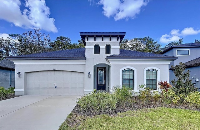 view of front of house with a garage, concrete driveway, a shingled roof, and stucco siding