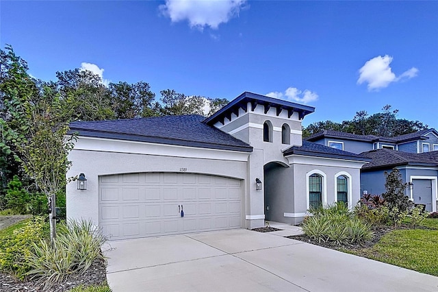 view of front of property featuring a garage, driveway, and stucco siding