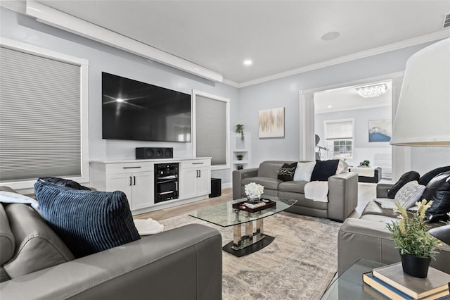 living room featuring ornamental molding and light hardwood / wood-style flooring