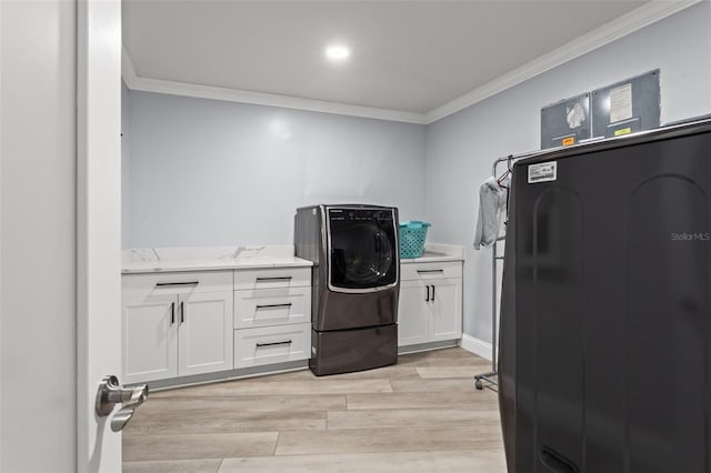 laundry room with cabinets, washer / dryer, light hardwood / wood-style floors, and crown molding