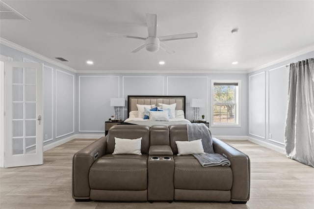 bedroom featuring ceiling fan, ornamental molding, and light wood-type flooring