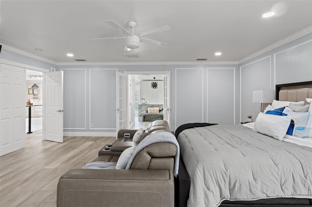 bedroom with crown molding, ceiling fan, and light hardwood / wood-style flooring