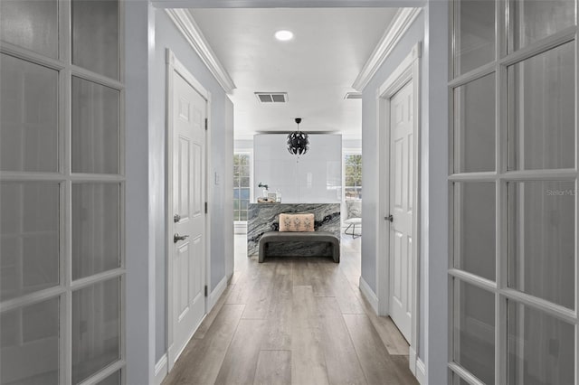 14485 Switch Back Rd, Brooksville, FL 34609 - hallway featuring light wood finished floors, recessed lighting, baseboards, and ornamental molding