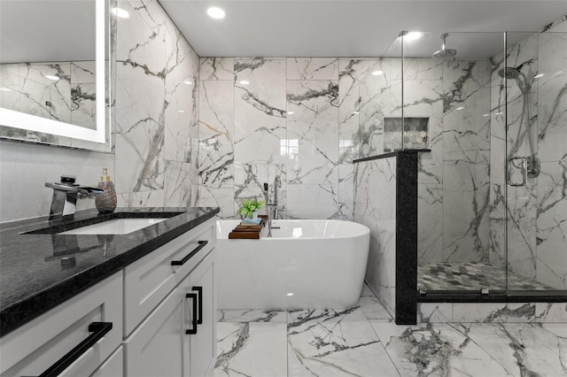 bathroom featuring vanity, shower with separate bathtub, and tile walls