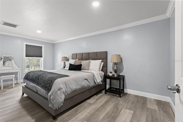 bedroom featuring light hardwood / wood-style floors and ornamental molding