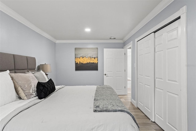 bedroom featuring wood-type flooring, a closet, and crown molding