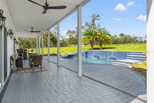 view of patio / terrace with ceiling fan and pool water feature