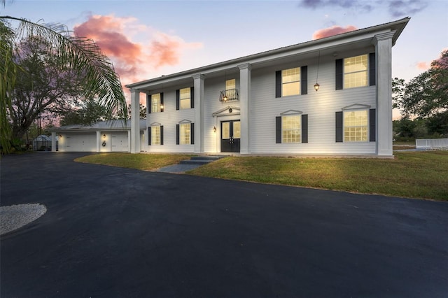 14485 Switch Back Rd, Brooksville, FL 34609 - neoclassical home featuring driveway and a garage