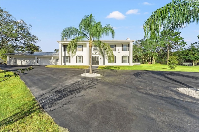 14485 Switch Back Rd, Brooksville, FL 34609 - neoclassical / greek revival house featuring a front lawn and a chimney