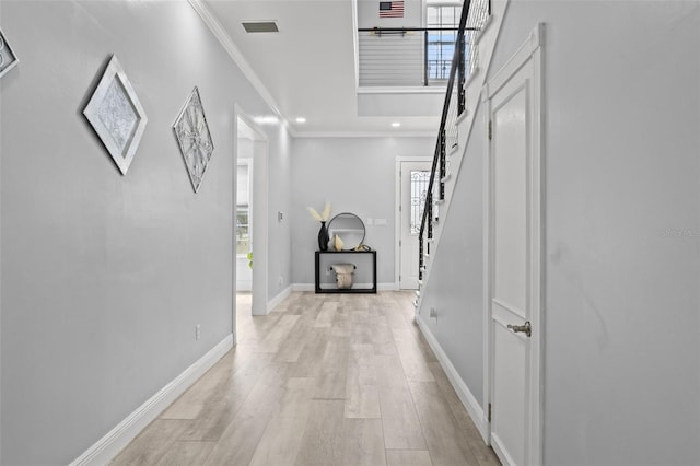 14485 Switch Back Rd, Brooksville, FL 34609 - hallway with ornamental molding, plenty of natural light, stairway, light wood-style floors, and baseboards