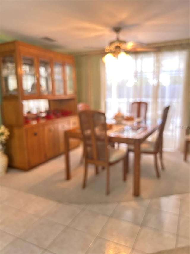 tiled dining room featuring ceiling fan