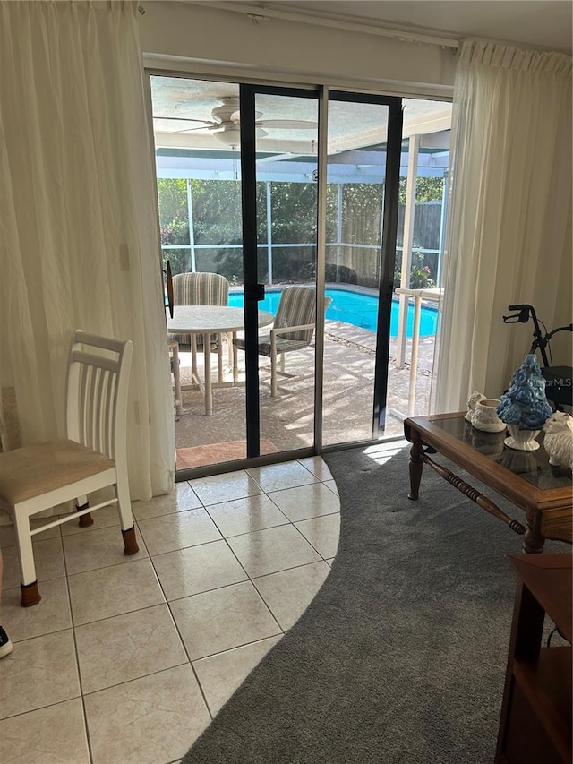 entryway with light tile patterned floors and ceiling fan